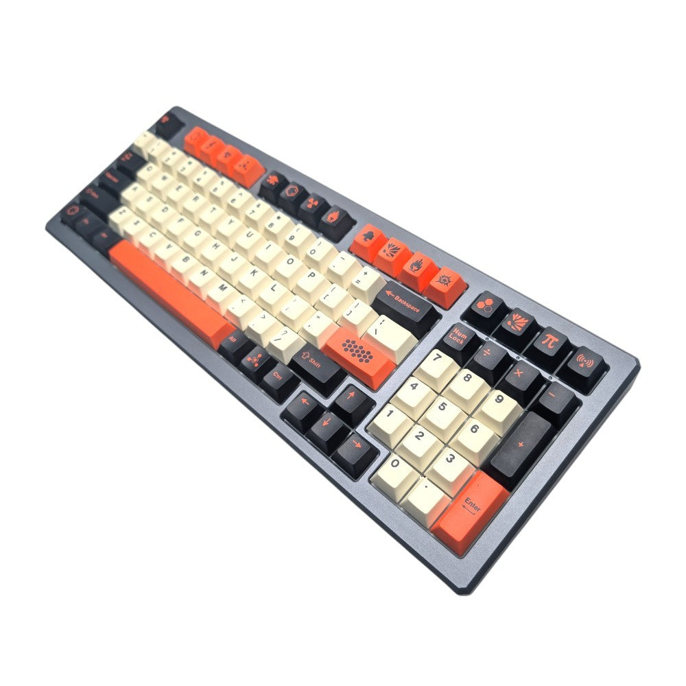 A mechanical keyboard with a dark gray chassis, featuring cream-colored keycaps, black keycaps, and orange accent keycaps, shown on a plain white background.