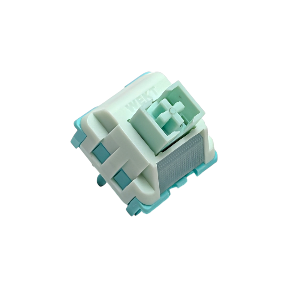 Detailed view of WEKT Nafu silent mechanical switches on a desk mat, showing the clean aesthetic of these high-performance components for custom keyboard builds.