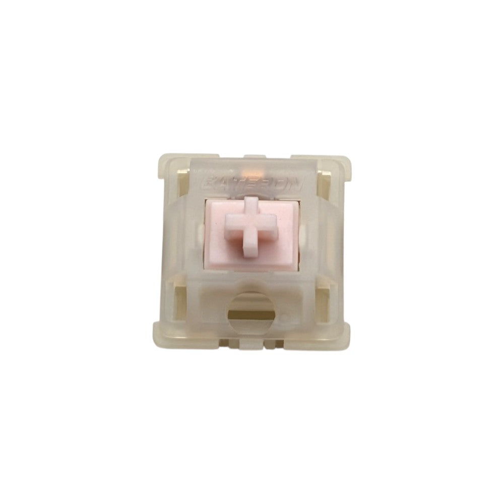 Top-down macro view of Gateron Milky Pink Pro linear switch showing pastel pink POM stem and milky translucent top housing.
