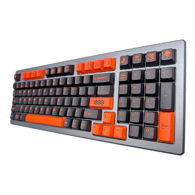 Angled shot of the keyboard showcasing the sleek black keycaps with bold orange alpha keys.