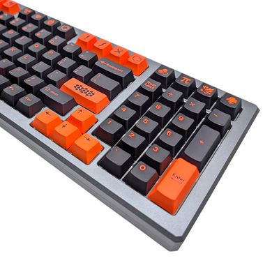 Macro view of unique accent keycaps with fire, explosion, and hexagon patterns.