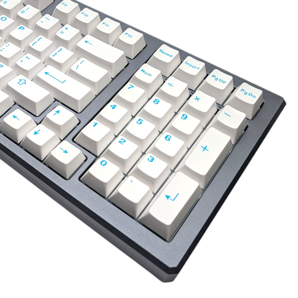 Close-up of crisp white alpha keycaps with vibrant turquoise/teal legends, showcasing ABS double-shot quality.