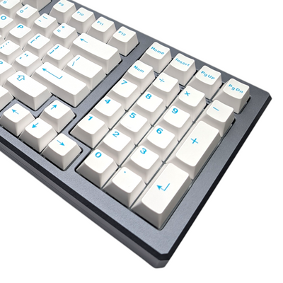 Close-up of crisp white alpha keycaps with vibrant turquoise/teal legends, showcasing ABS double-shot quality.