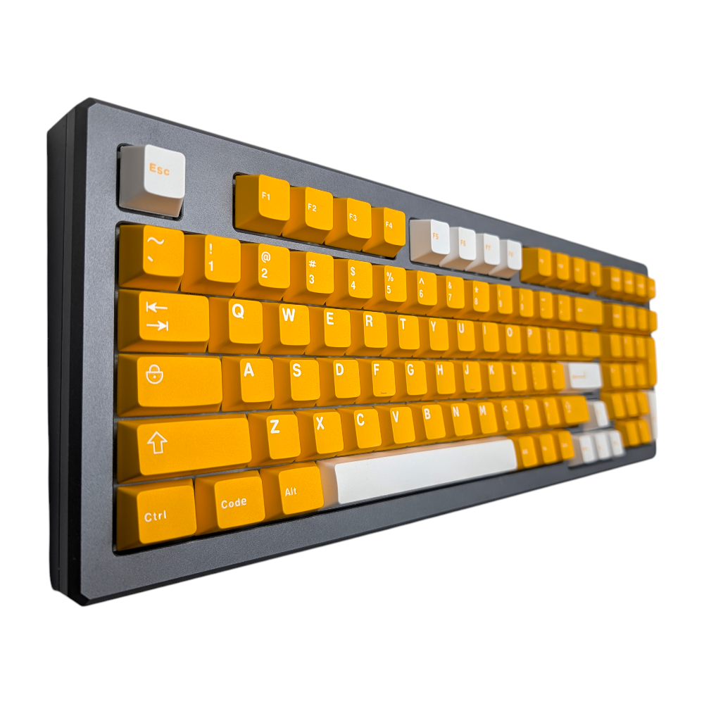 Angled perspective of 133-piece Midas Touch Gold keycap set in Cherry MX profile on a gray mechanical keyboard.