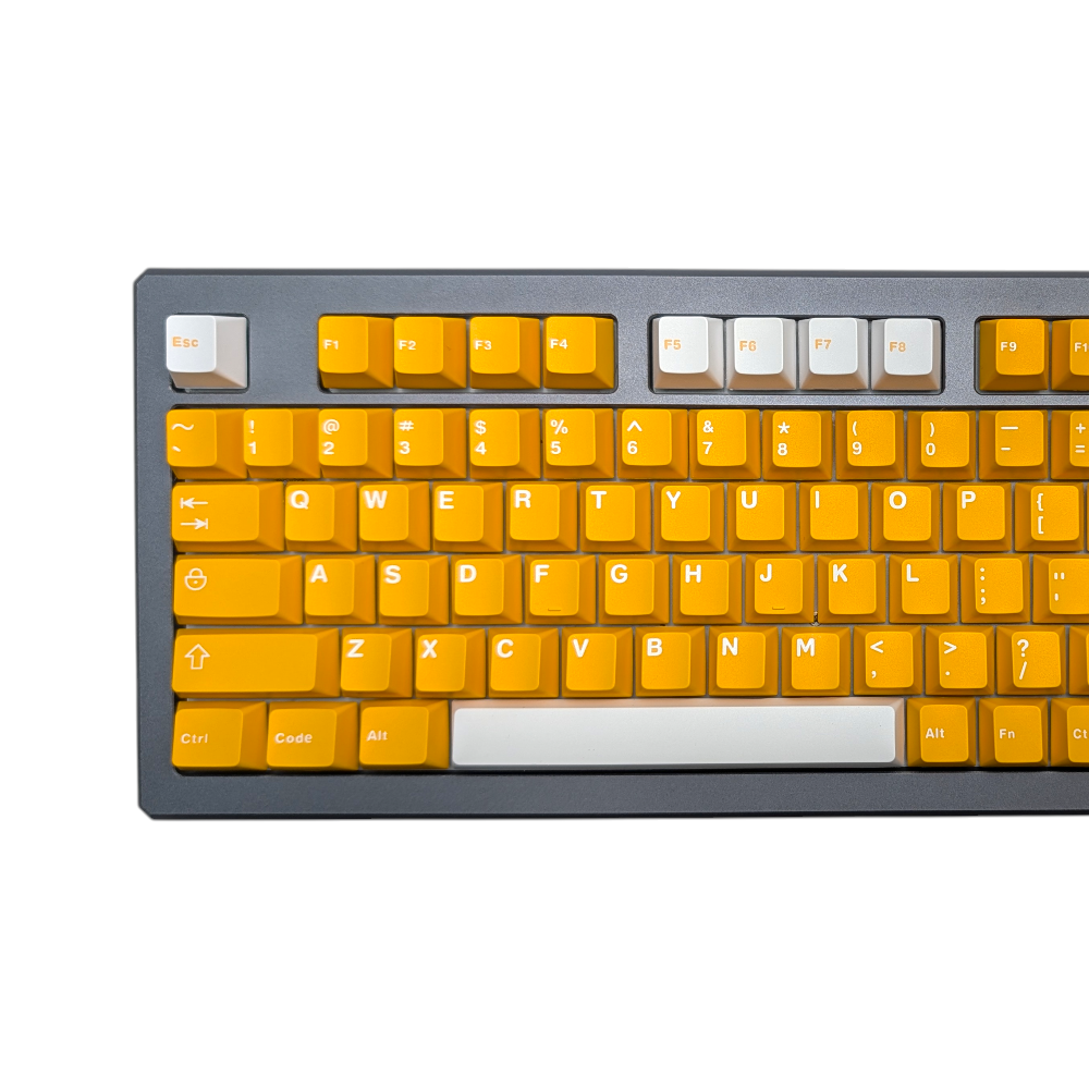 Close-up of vibrant yellow alpha keycaps with white legends, showcasing ABS double-shot quality.
