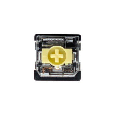 A single Gateron wireless mechanical switch in a top-down view, featuring a black housing, a gold gold-plated contact point with a plus sign, and a clear plastic top cover.