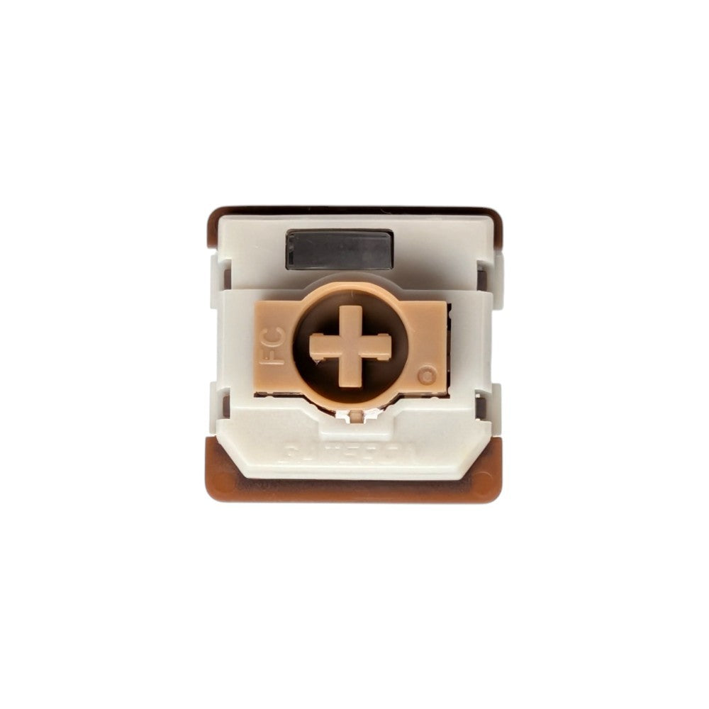 A close-up of a mechanical keyboard switch component, showing the FC (front cap) and HGS (hexagonal gear switch) internal structure, with a white plastic body, brown accents, and a copper-colored FC ring.