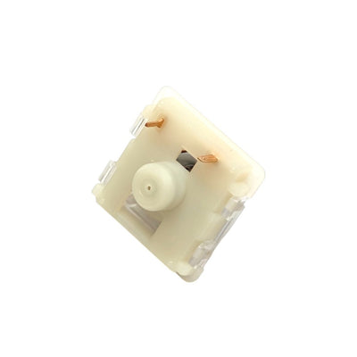 A single mechanical keyboard switch in a warm cream or off-white plastic housing, shown from an angled top-down view on a solid white background.
