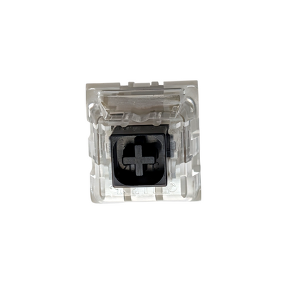 Close-up of a heavy linear Kailh Box Black switch showing the MX-style cross stem and clear housing.