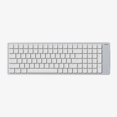 A minimalist white wireless keyboard with a slim profile and a small vertical brand logo on the right edge, shown from a top-down perspective against a light gray background.