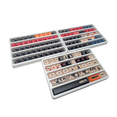 A set of mechanical keyboard keycaps arranged in trays, featuring various designs and colors including red, orange, black, beige, and Naruto-themed graphics, on a plain white background.
