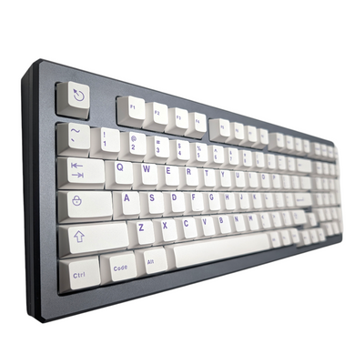 Angled perspective of 133-piece Polar Purple keycap set in Cherry MX profile on a gray mechanical keyboard.