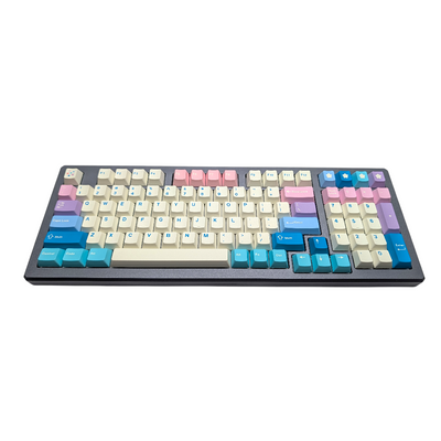 Close-up view of multi-colored pastel PBT keycaps with blue legends, including numerical pad and blue spacebar.