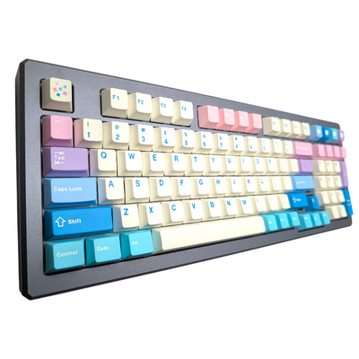 Close-up view of multi-colored pastel PBT keycaps with blue legends, including numerical pad and blue spacebar.