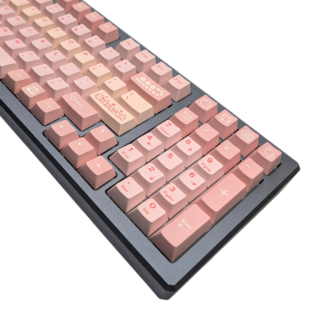 Top-down view of a mechanical keyboard featuring various shades of pink keycaps.