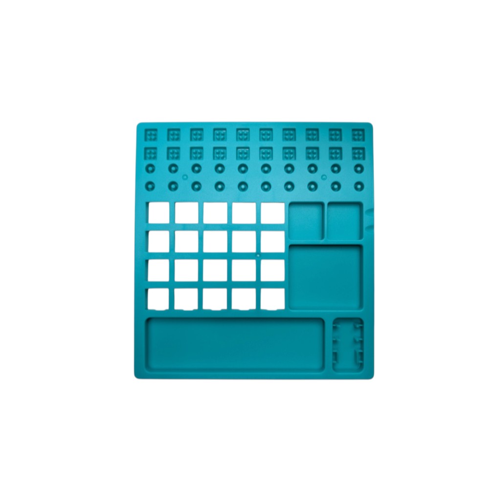 Top-down view of teal plastic lube station showing layout for 20 switch housings, 30 stems, 20 springs, and storage compartments.