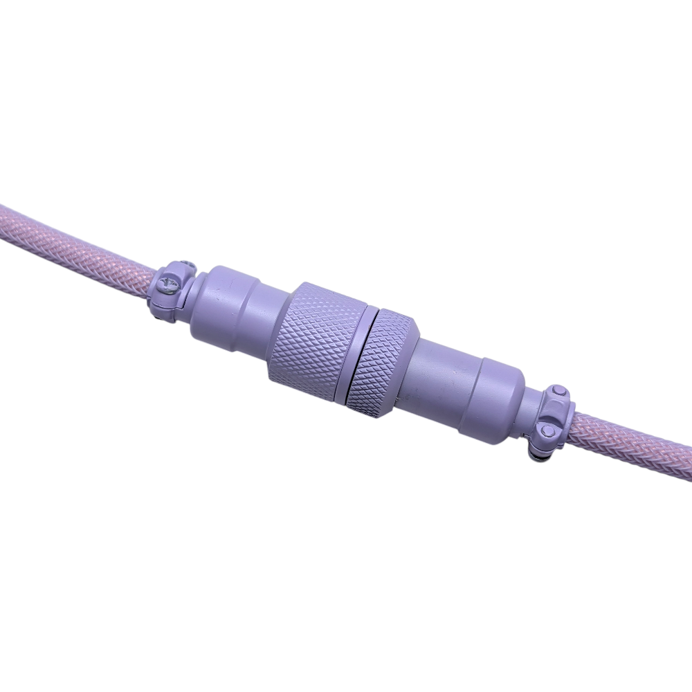 Detailed shot of the lilac purple powder-coated GX16 aviator connector on a custom mechanical keyboard coiled cable.