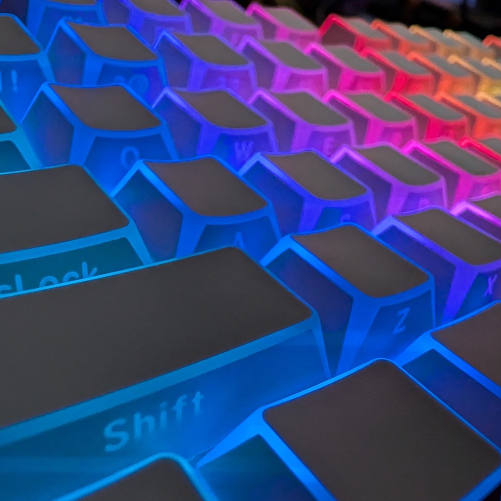 Edge Glow OEM keycaps by Thock King illuminated with colorful backlighting in low light environment.