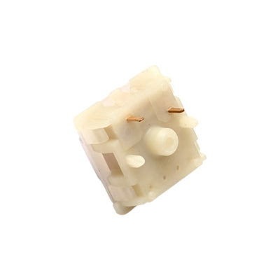 Bottom angled shot of Gateron Milky Purple Pro switch highlighting PCB mounting legs and stem pole orifice.