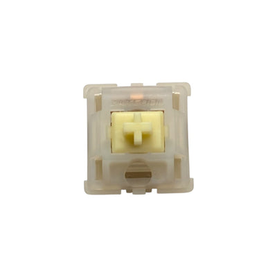 Top-down macro view of Gateron Milky Yellow Pro heavy tactile switch showing yellow POM stem and translucent milky top housing.