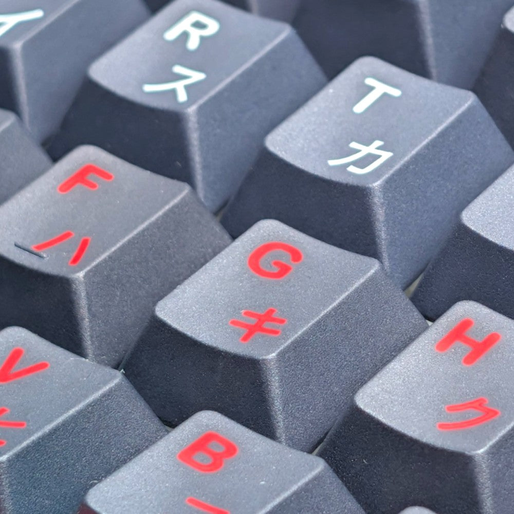 Macro view of clean dye-sublimated split white and red katakana legends on Thock King PBT keycaps.