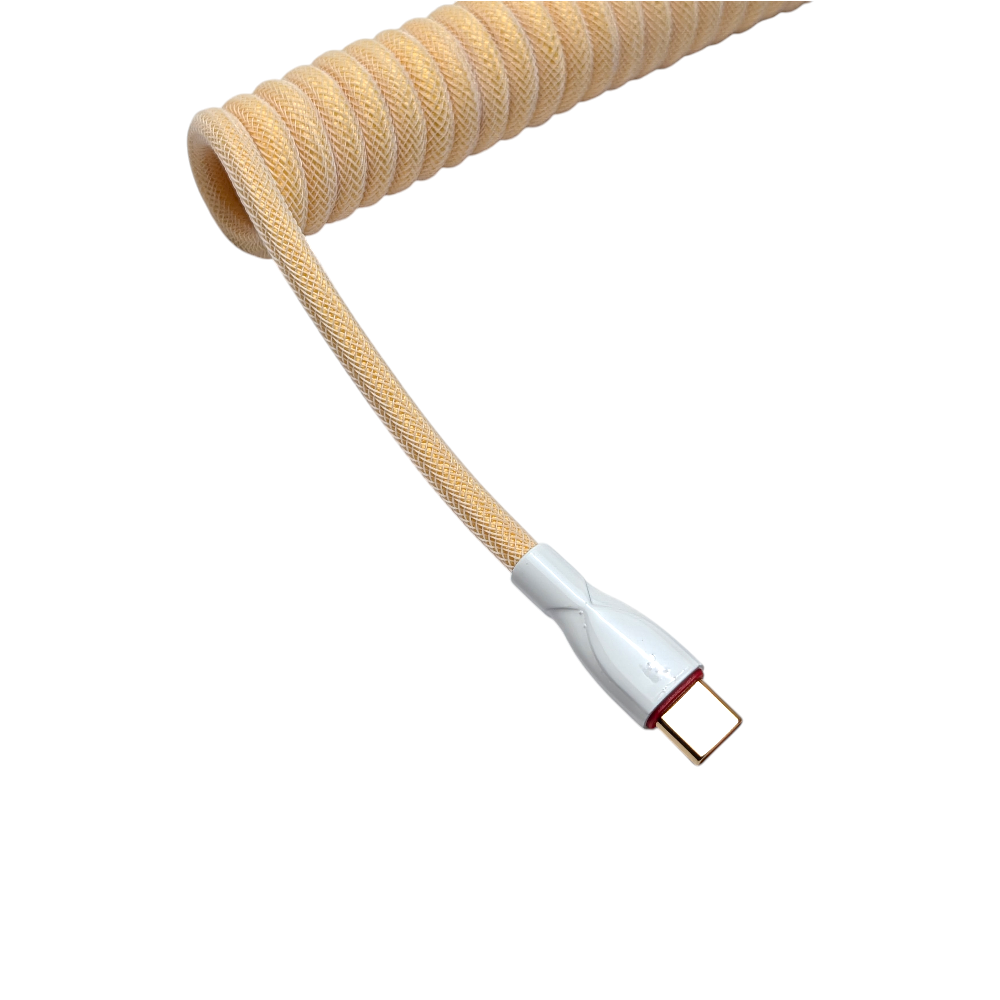 Close-up of the Ivory Cream coiled USB-C to USB-A cable featuring professional powder-coated metal hardware and a minimalist aesthetic.