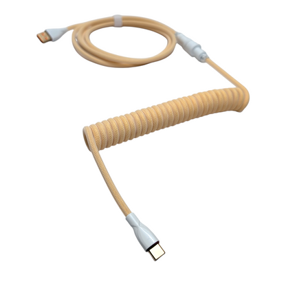 Ivory Cream coiled aviator cable showing the heavy-duty metal GX16 detachable connector with a matte powder-coated ivory finish.