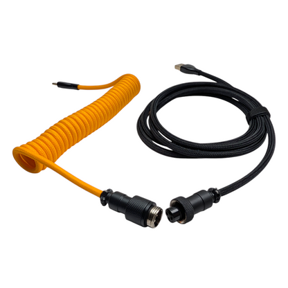 Handmade USB-C to USB-A coiled cable for mechanical keyboards featuring durable onyx metal hardware and vibrant orange double-sleeving.