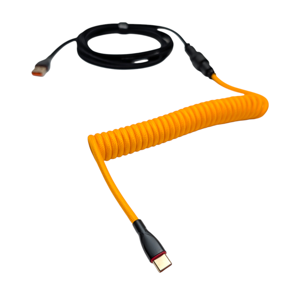 Detailed view of the tight, professional coil on an Onyx Orange keyboard cable, showing the high-quality metal powder-coated finish.