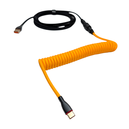 Detailed view of the tight, professional coil on an Onyx Orange keyboard cable, showing the high-quality metal powder-coated finish.