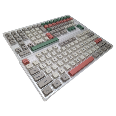 Full 141 piece set of Thock King Retro 9009 PBT XDA keycaps arranged in storage packaging trays.