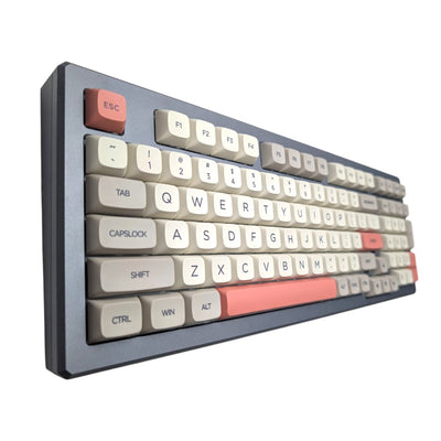 Angled side view of Retro 9009 PBT XDA keycaps showcasing salmon pink enter key and spacebar by Thock King.